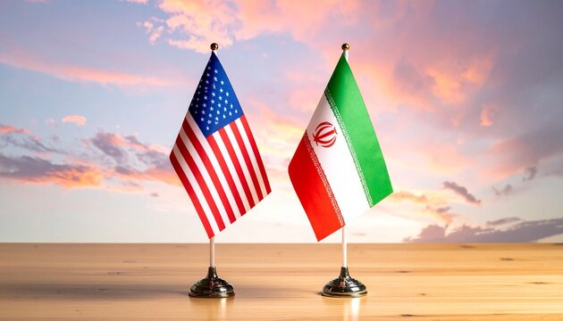 Two table flags—United States and Iran—stand side by side on a wooden surface