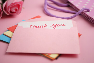 Thank you cards on a soft pink background with flowers