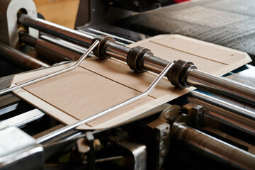 Innovation in packaging machinery efficiently folds cardboard flaps for seamless box assembly in a...