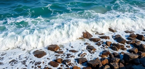 Ocean waves crashing on a rocky shore, sea foam and spray, sky, water
