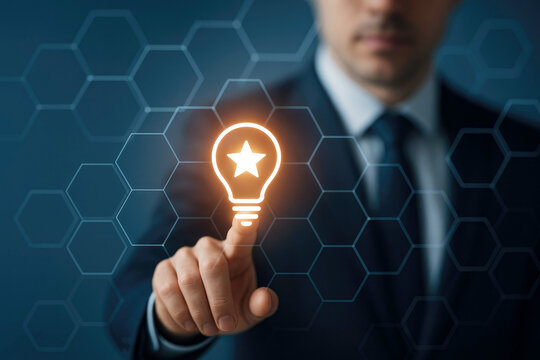 Businessman's Finger Touches Glowing Light Bulb with Star Icon on Digital Hexagonal Network Background