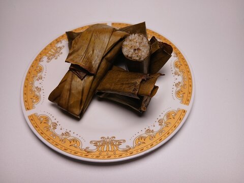 Lapek sagan, Minangkabau traditional food, A mixture of pulut rice with grated coconut and banana wrapped in banana leaves then cooked by steaming.