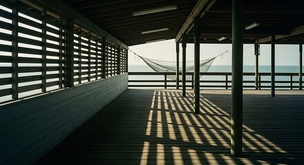 Pier walkway with louvered walls and hammock overlooking the ocean.