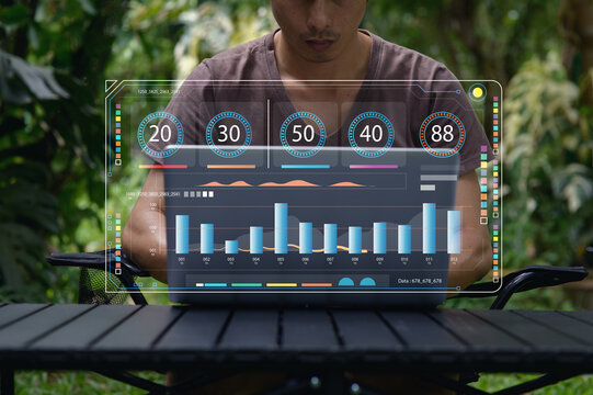 Man Working Outdoors with Laptop and Data Visualization Graphics