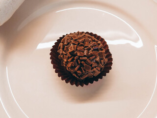 Brazilian brigadeiro close-up on a beige ceramic plate