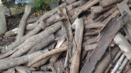 Firewood stacked in a pile. Cut wooden logs.