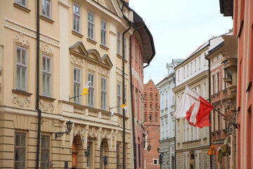 Fototapeta premium Historical Houses with Polish Flags in Kraków, Poland