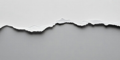 Torn white paper edge against a neutral gray background, creating a dramatic contrast and texture