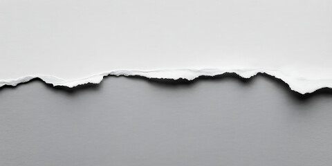 Torn white paper edge against a solid gray background, creating a stark contrast