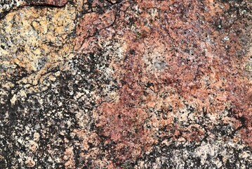 Abstract: Close-Up of Colourful Australian Granite with Orange, Yellow, and Pink Tones