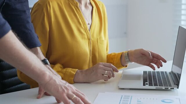 Business team reviewing financial data on laptop, analyzing charts and strategizing corporate workflow, collaborating toward shared business objectives. Business people - Powered by Adobe