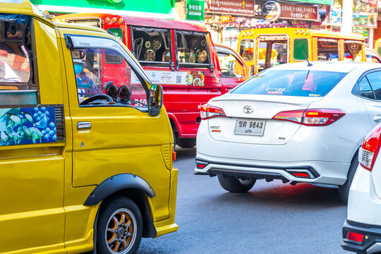 Yellow public transportation tuk tuk car taxi in Phuket Thailand.