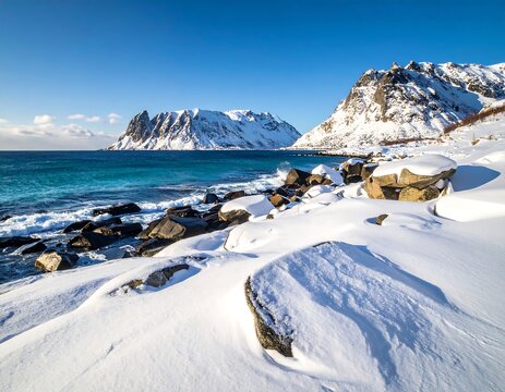 Snowy coastline with mountains, turquoise water, and a bright blue sky - Powered by Adobe