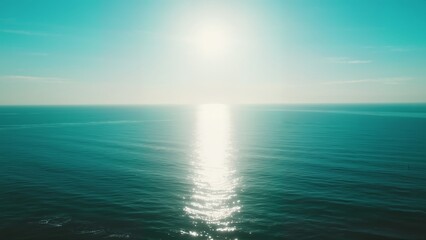 Sunlight reflecting on calm ocean surface under clear sky