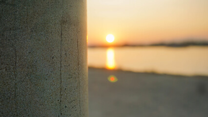 lampposts in the harbor with a blurry background, a harbor full of fishing boats and a calm sea in the morning