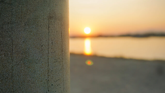lampposts in the harbor with a blurry background, a harbor full of fishing boats and a calm sea in the morning