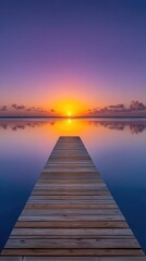 Fototapeta premium Wooden Pier Extending Towards a Vibrant Sunset Over a Calm Tropical Ocean with Purple and Orange Hues Reflected in the Water