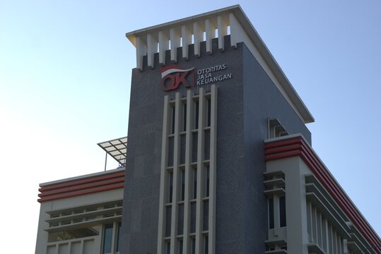 Low angle view of (OJK) indonesia financial service authority office building against blue sky