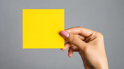 Women hand hold yellow adhesive note