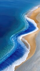 Stunning Overhead View of Ocean Foam Patterns and Golden Sand Beach Sparkling Under Bright Sunlight