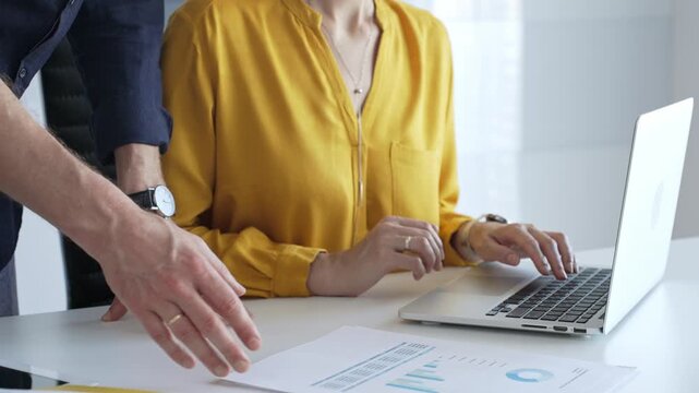 Professional team reviewing financial data on laptop, analyzing charts and strategizing corporate workflow, collaborating toward shared business objectives. Business people concept - Powered by Adobe