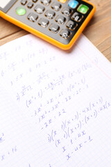 Naklejka premium Copybook with maths formulas and calculator, closeup
