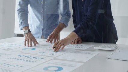 Professional business team analyzing financial reports, sharing insights and planning strategic...