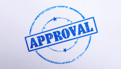 Official Approval Seal: A crisp, blue approval stamp boldly proclaims APPROVED within a circular border, communicating a message of confirmation and authority.