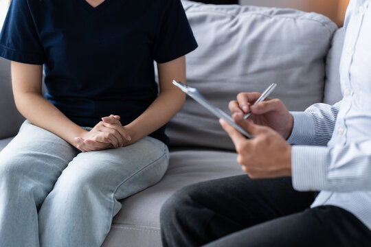 sad female sitting on sofa Patient discussing mental health issues with psychologist. depressed asian woman mental health treatment
