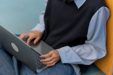 Young Asian Student Learning Online on Laptop at University