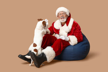 Santa Claus with cute Jack Russell Terrier dog on brown background