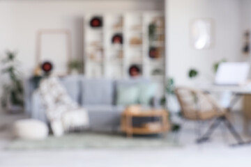 Blurred view of light living room with sofa, synthesizer and vinyl disks