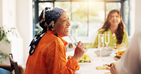 Mature, happy woman and laughing with feast for funny joke, humor or comedy at dinner table in...