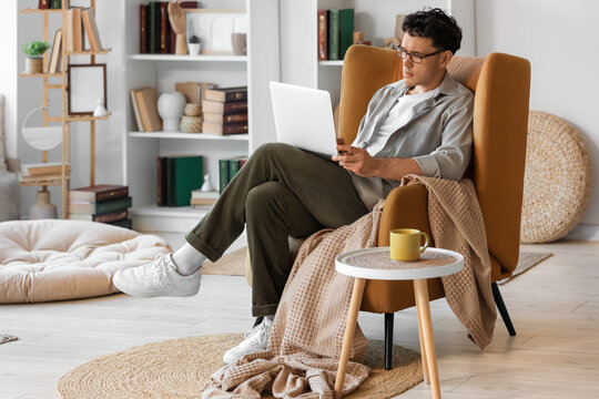 Male screenwriter with laptop writing script in office