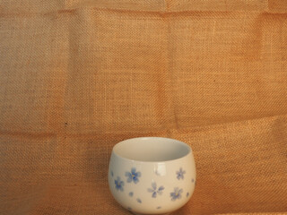 Empty coffee cup on brown cloth for copy space about snacks