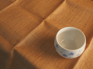 Empty coffee cup on brown cloth for copy space about snacks