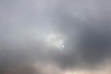 Fototapeta premium gray sky covered with thick clouds and thick fog that slowly dissipates from sunlight, dreary gray sky and thick fog that obscures the view