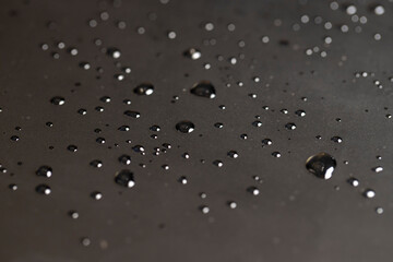 surface covered with water, a large number of drops of water makes the waterproof smooth surface completely wet, part of the phone screen is covered with drops of water