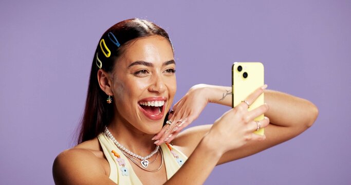 Beauty, energy and selfie with influencer woman in studio for product review on social media. App, haircare and smile of Gen Z content creator isolated on purple background for post or update