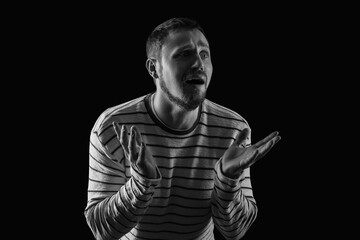 Stressed young man on black background