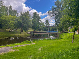 a green city park with a river in the center of Vitebsk