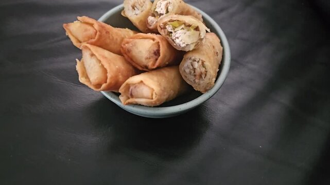 pistachio nuts in a bowl,Lumpia bihun,Risol bihun,Fried spring roll with filled vermicelli and vegetables.Indonesian fried snack,Gorengan,Various Indonesian fritter,usually eat for snack,breakfast and
