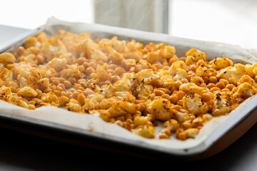 roasted hot cauliflower and chickpeas in tray close up