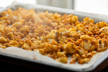 roasted hot cauliflower and chickpeas in tray close up