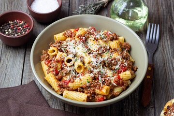 Pasta with bolognese sauce and cheese. Italian cuisine. Traditional recipe.