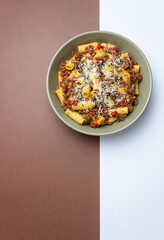 Pasta with bolognese sauce and cheese. Italian cuisine. Traditional recipe.