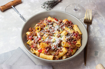 Pasta with bolognese sauce and cheese. Italian cuisine. Traditional recipe.