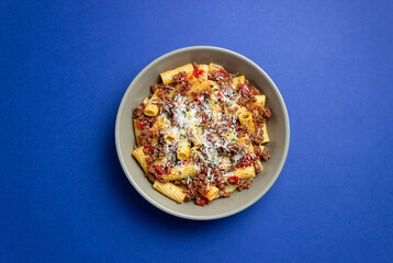Pasta with bolognese sauce and cheese. Italian cuisine. Traditional recipe.