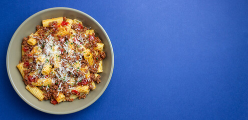 Pasta with bolognese sauce and cheese. Italian cuisine. Traditional recipe.