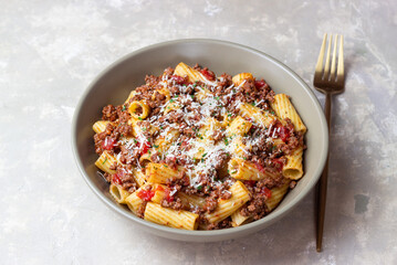 Pasta with bolognese sauce and cheese. Italian cuisine. Traditional recipe.